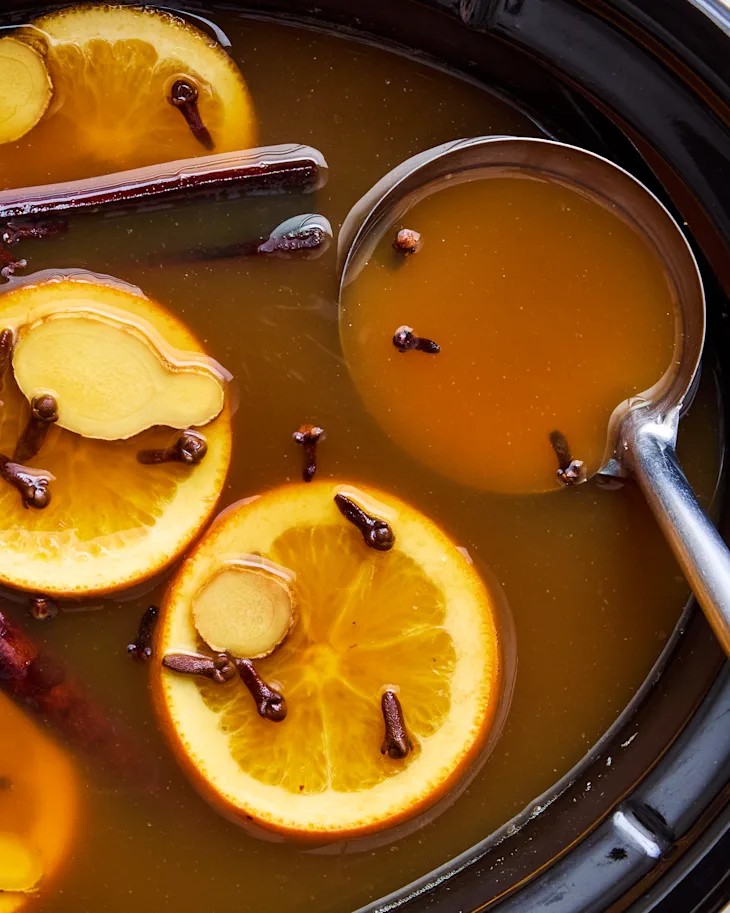 Apple Cider with Orange Slices, Clove, Ginger, and Cinnamon Sticks